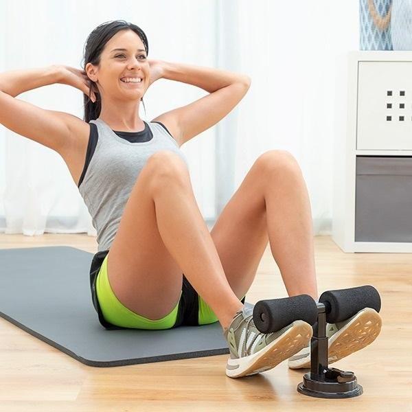 Woman using sit-up bar ab exerciser on yoga mat, home fitness equipment by IndianChic